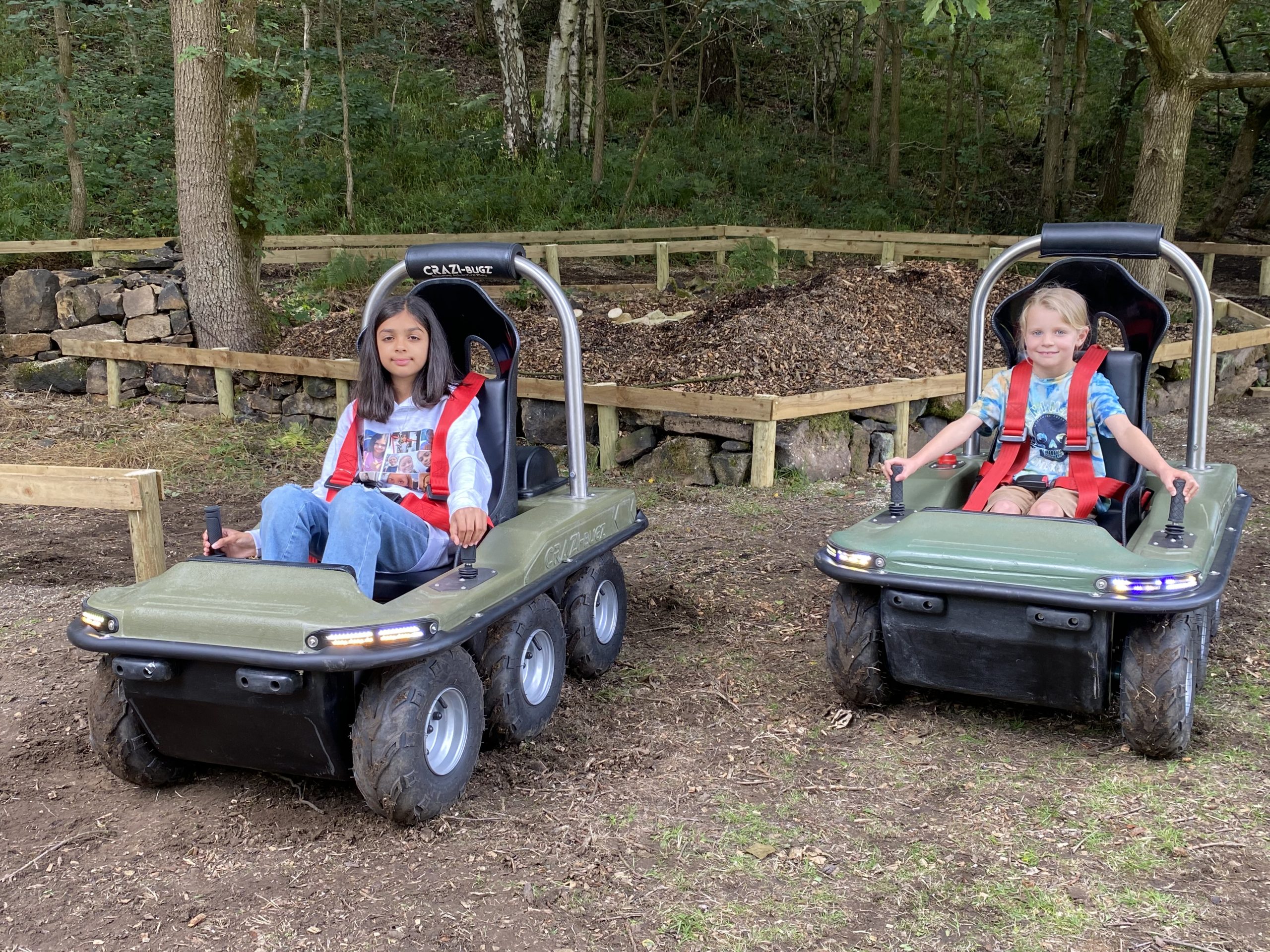 Children riding Crazi-Bugz electric ride-on vehicles at Holme Valley Caravan Park